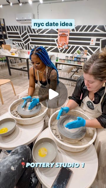 two women in aprons are making pottery