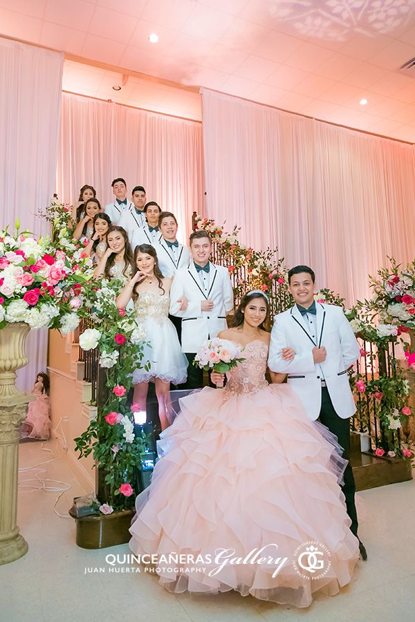 a group of people standing next to each other in front of a wedding ceremony arch