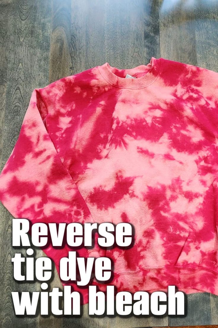 a pink tie - dye sweatshirt with the words reverse tie dye with bleach