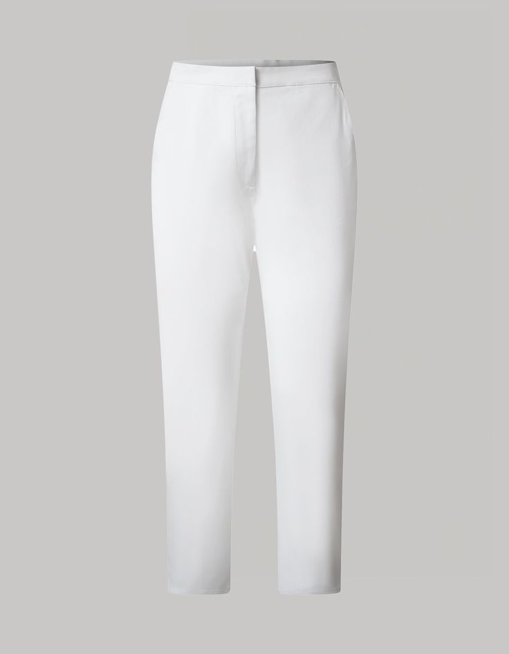 The Jeanne capri pants are the essence of timeless comfort with a touch of vintage femininity. Crafted from organic cotton Gabardine stretch fabric, these pants offer a hint of stretch and are a breathable essential designed for comfort on warm-weather days. With a high-rise waist and falling just below the knee, the tailored silhouette and classic white color make them versatile for any occasion. Elegant Stretch Pants For Daywear, Chic Cotton Tapered Leg Capris, Classic Bottoms For Daywear, Chic Straight Cotton Capris, Classic Long Pants For Daywear, Elegant Straight Leg Stretch Capris, Fitted Cropped Leg Loungewear Pants, Chic Cotton Ankle-length Capris, Elegant Stretch Cropped Leg Capris