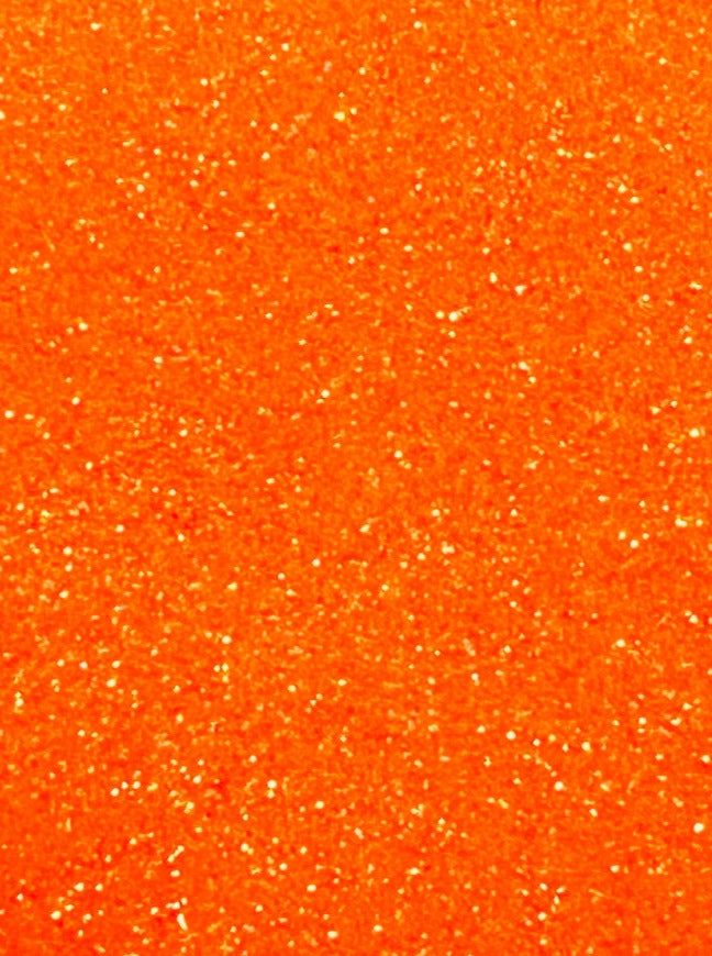 an orange glitter background with lots of small sparkles on the bottom and side of it