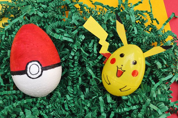 two pokemon eggs are sitting in some green grass and one has a pikachu face on it