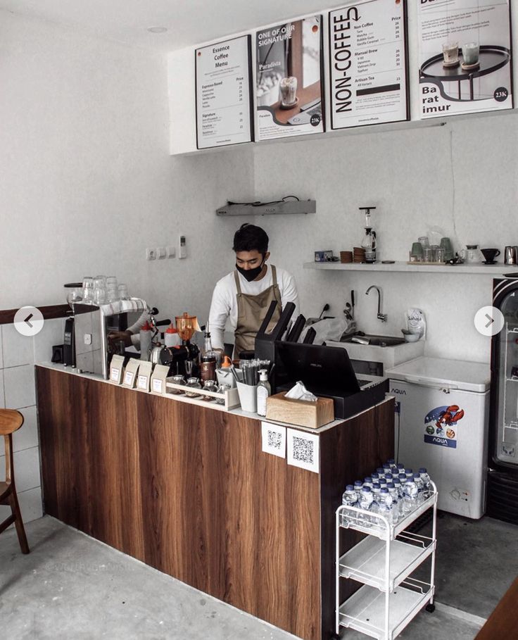 a man standing behind a counter in a kitchen