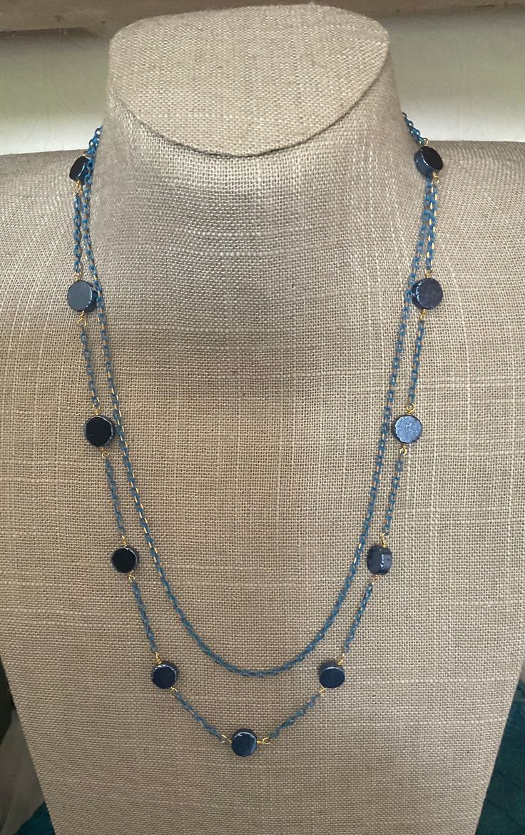 Two strand necklace in blue and gold. One strand is just chain the second has blue pyrite coins. Elegant Blue Delicate Chain Necklace, Elegant Blue Chain Necklace For Party, Elegant Blue Beaded Chain Necklace, Elegant Blue Necklace With Gold Chain, Elegant Blue Jewelry With Gold Chain, Elegant Blue Long Chain Necklace, Elegant Long Blue Chain Necklace, Elegant Blue Beaded Necklaces With Chain, Elegant Blue Beaded Necklace With Adjustable Chain