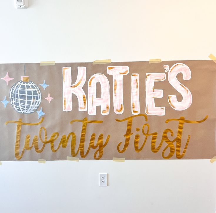 a sign that says kate's twenty first on the side of a white wall