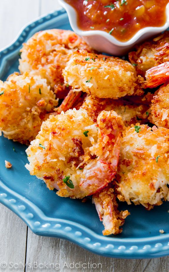 some fried food on a blue plate with dipping sauce