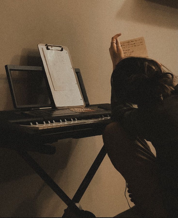 a person sitting at a desk with a keyboard