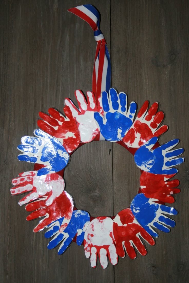 red, white and blue handprinted wreath on wood