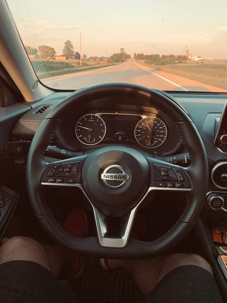 the interior of a car with dashboard, steering wheel and gauges on both sides