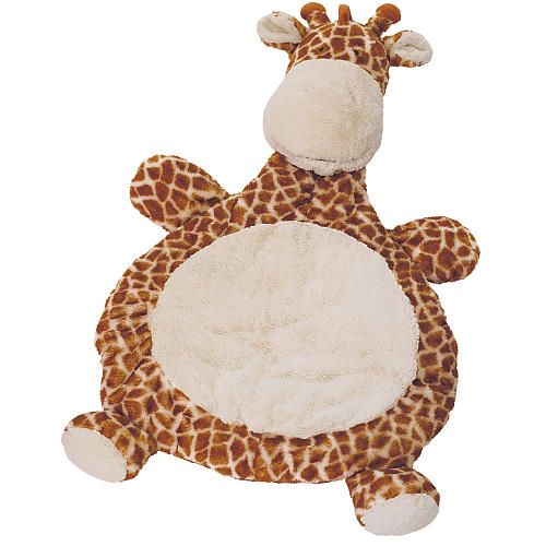 a stuffed giraffe laying on top of a rug