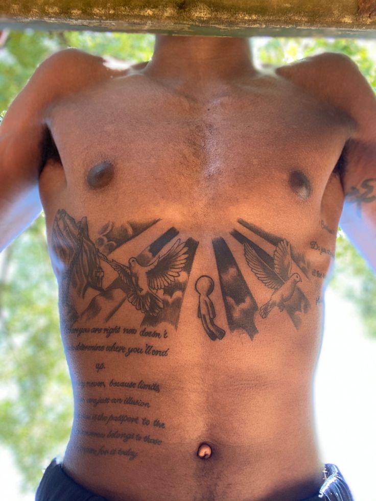 a shirtless man with tattoos on his chest