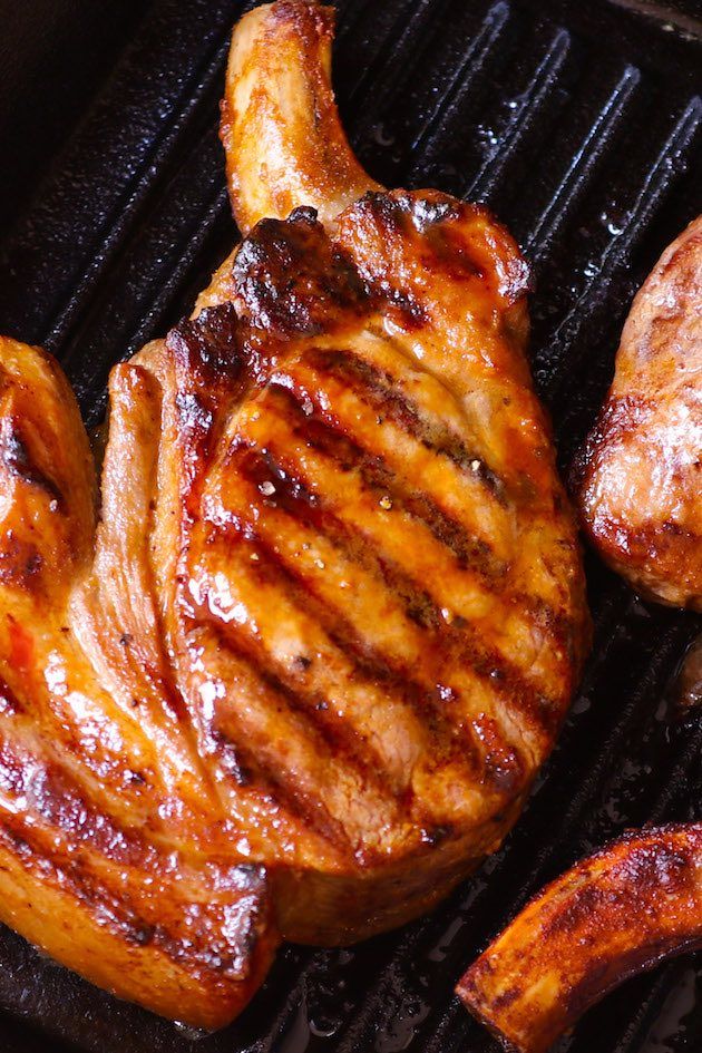 two pieces of meat cooking on a grill