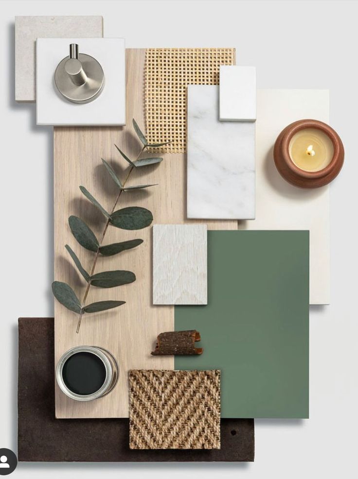 an assortment of different items on top of a wooden table next to a candle and some leaves