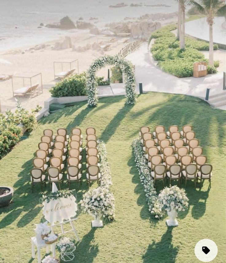 an outdoor ceremony setup with chairs and flowers