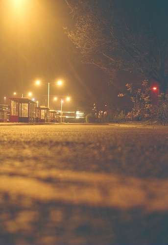 an empty parking lot at night with street lights