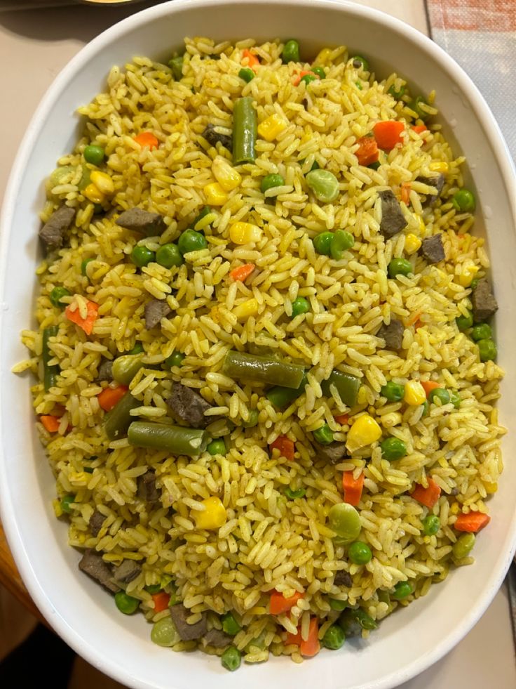 a white bowl filled with rice and vegetables