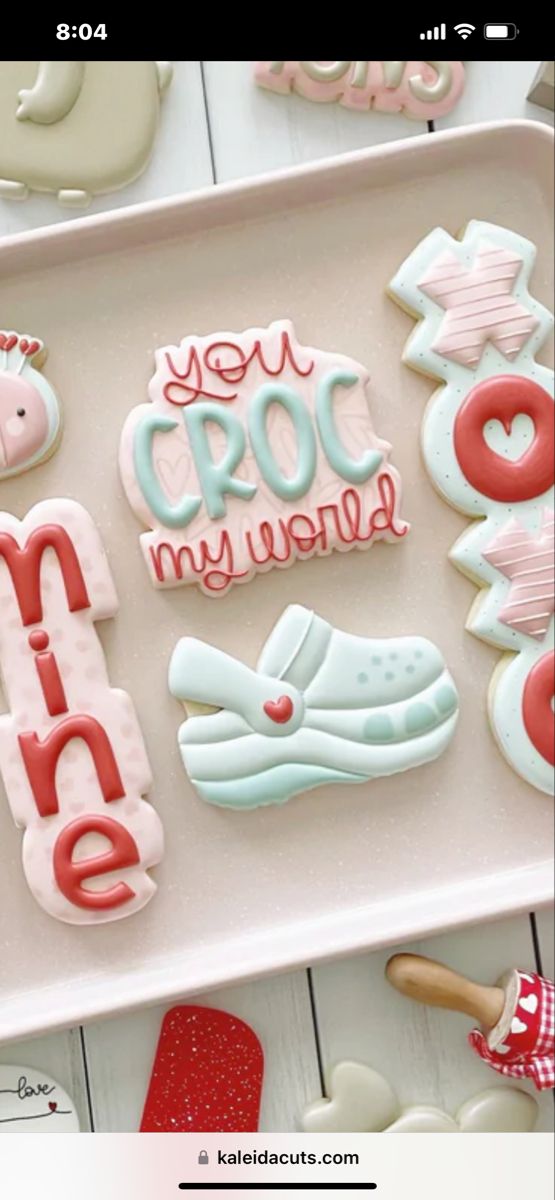 some cookies that are on a tray with the words you croc my world written in them