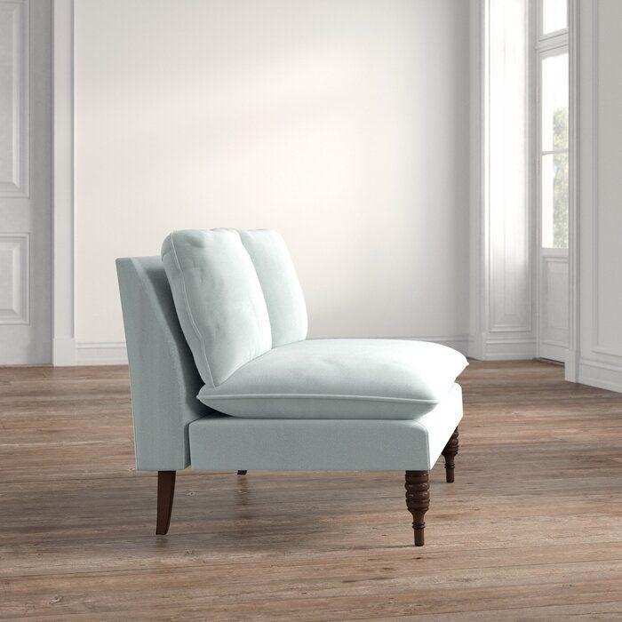 a white chaise lounge chair sitting on top of a hard wood floor next to a window