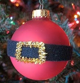 a red ornament hanging from a christmas tree