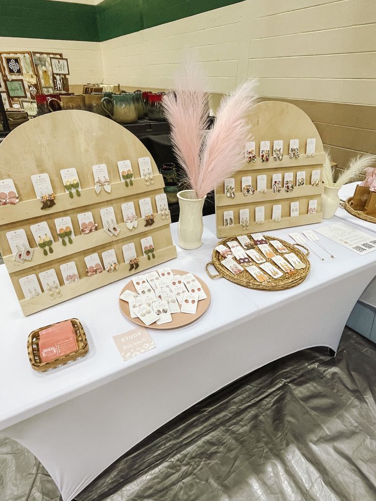 the table is set up with several items for sale on it, including cookies and pastries