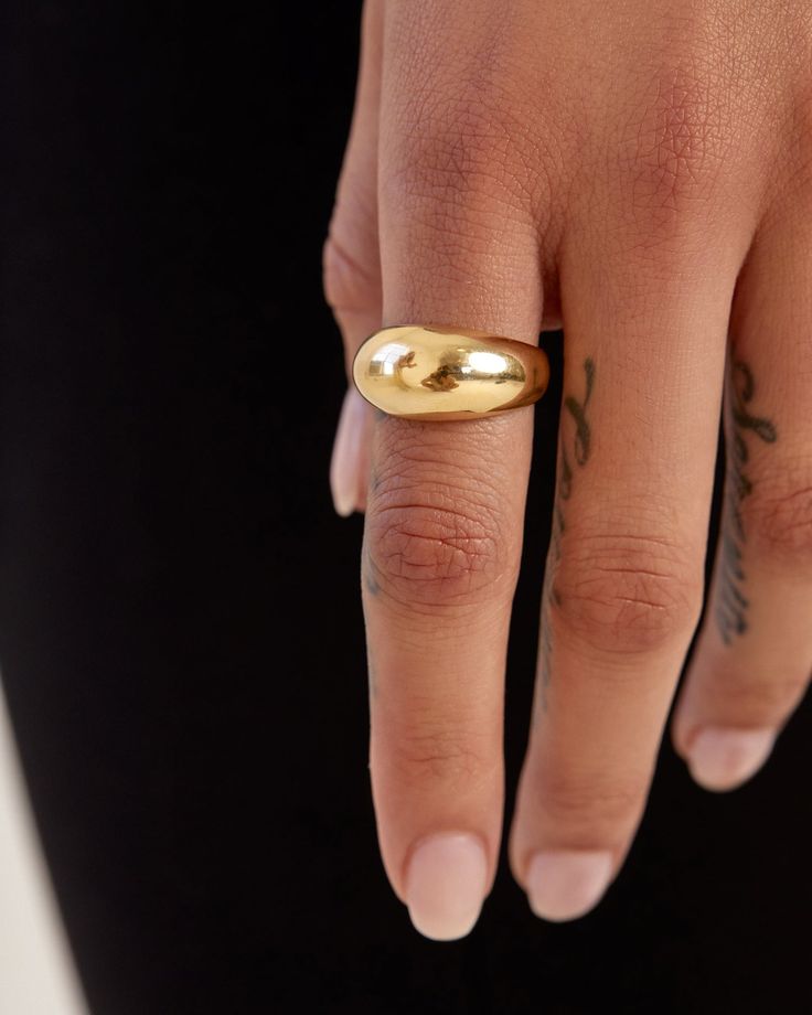 Smooth and futuristic, our 14k gold Dome Ring was created to make a statement while remaining compact enough to stack with other rings alike. Its shiny, polished surface offers a chunky presence and makes a statement solo but looks equally as prodigious when layered with a handful of rings. The Large Dome Ring has been hollowed out for ultra-lightness and measures 10mm at its widest, tapering to 3.5mm in the back for comfortable wear. Made to order. Please allow one week for production. Modern Yellow Gold Signet Ring With Shiny Finish, Modern Wide Band Gold Ring, Luxury Gold Wide Band Ring For Everyday, Modern Gold Jewelry With Thick Band, Luxury Gold Dome Ring For Everyday Wear, Luxury Gold Dome Ring For Everyday, Modern Wide Band Stackable Rings With Polished Finish, Luxury Everyday Gold Dome Ring, Modern Tarnish-resistant Wide Band Ring