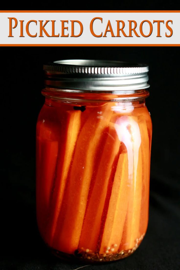 a jar filled with sliced carrots sitting on top of a black tablecloth covered floor