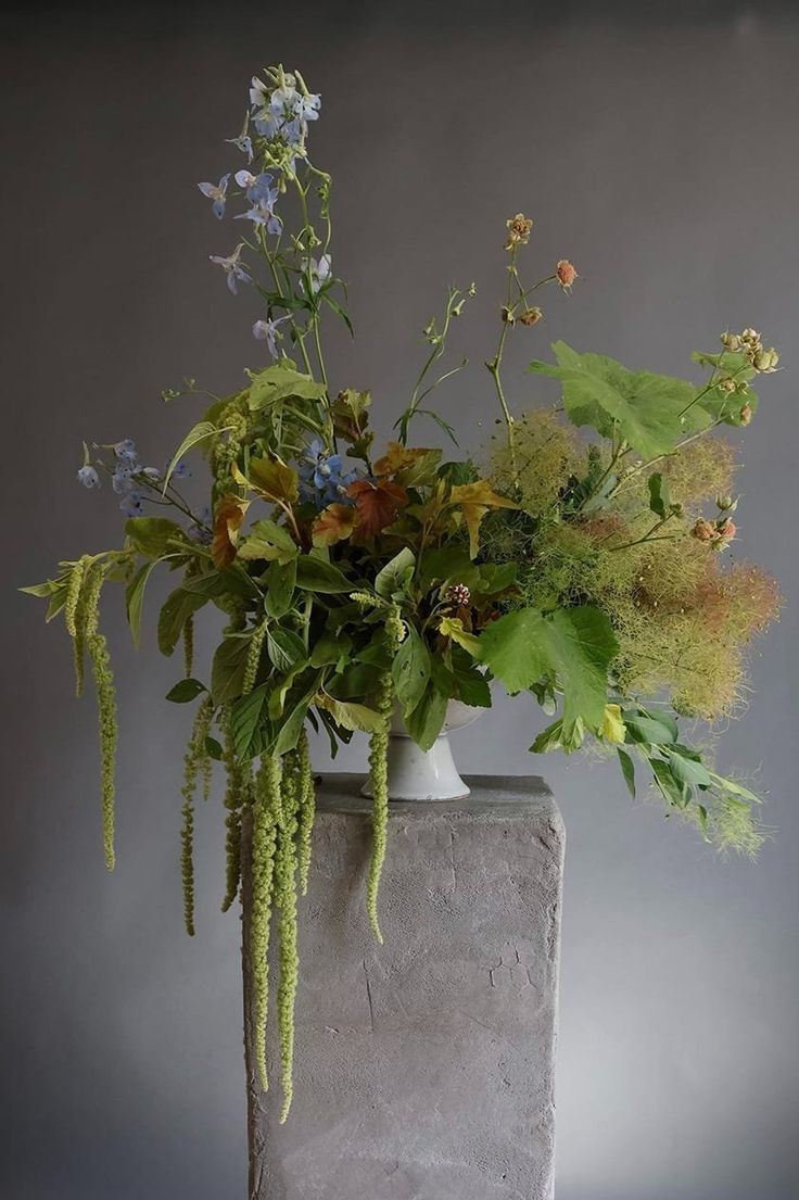 a vase filled with lots of different types of flowers