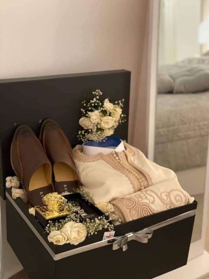 a suitcase with shoes and flowers in it