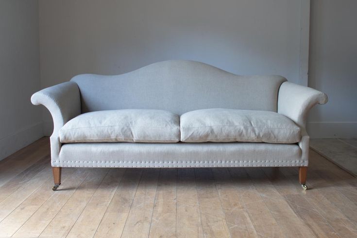 a white couch sitting on top of a hard wood floor