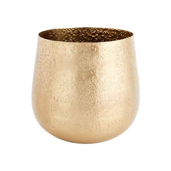 a large gold vase sitting on top of a white table