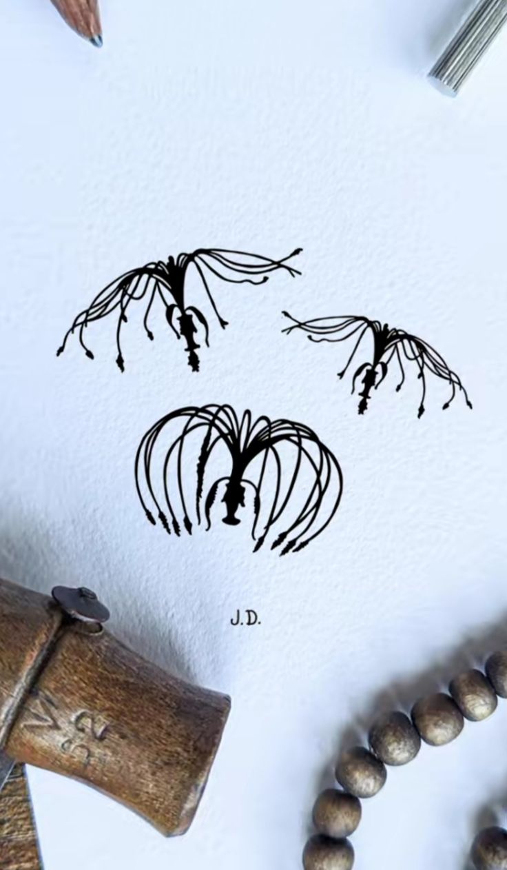 an ink drawing of three flowers on top of a white paper next to a hammer