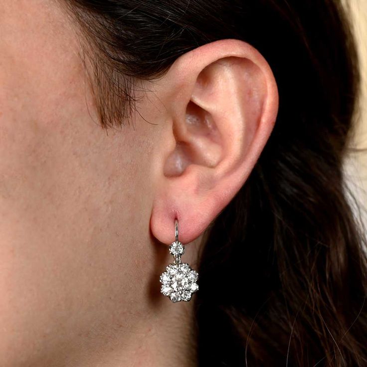 A Lovely Pair Of Platinum And Diamond Drop Earrings Featuring A Cluster Of Old European Cut Diamonds Dazzling Diamond Cluster Drop Earrings, Diamond Cluster Dangle Earrings With Prong Setting, Diamond Cluster Drop Earrings In Diamond White, Timeless Platinum Drop Diamond Earrings, Timeless Platinum Diamond Drop Earrings, Formal Diamond Drop Cluster Earrings, Formal Diamond Cluster Drop Earrings, Platinum Cluster Diamond Earrings For Formal Occasions, Platinum Earrings With Single Cut Diamonds For Wedding