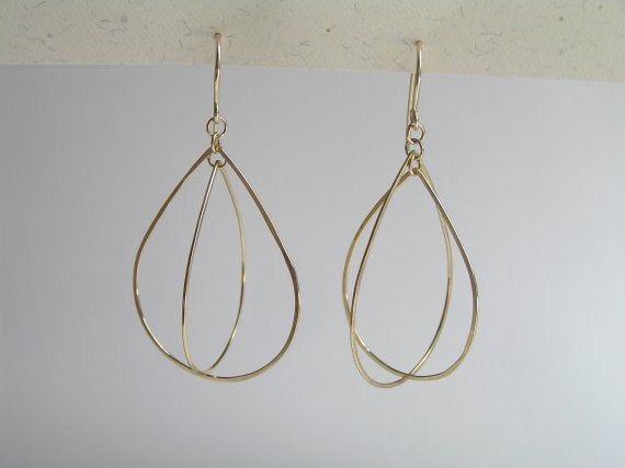 Gorgeous and light 14k gold dangle mobile earrings. 2 gold teardrops, made of hammered 14k gold wire, dangling like a mobile. Lovely, airy and light, these delicate earrings are constantly moving and changing. App. 5 cm/2 inch long from top to bottom. You can see a different version of those earrings (with aquamarines) here: http://www.etsy.com/listing/74721504/mobile-drop-earrings-with-aquamarine-14k To get back to my shop click here: http://www.etsy.com/shop/DaliaShamirJewelry?ref=si_shop Contemporary Teardrop Yellow Gold Earrings, Contemporary Yellow Gold Teardrop Earrings, Modern Gold Briolette Earrings, Modern Gold Teardrop Earrings In Sterling Silver, Modern Dangle Teardrop Earrings For Anniversary, 14k Gold Teardrop Linear Earrings For Anniversary, Everyday 14k Gold Teardrop Linear Earrings, Modern 14k Gold Teardrop Linear Earrings, Yellow Gold Dangle Teardrop Earrings For Everyday