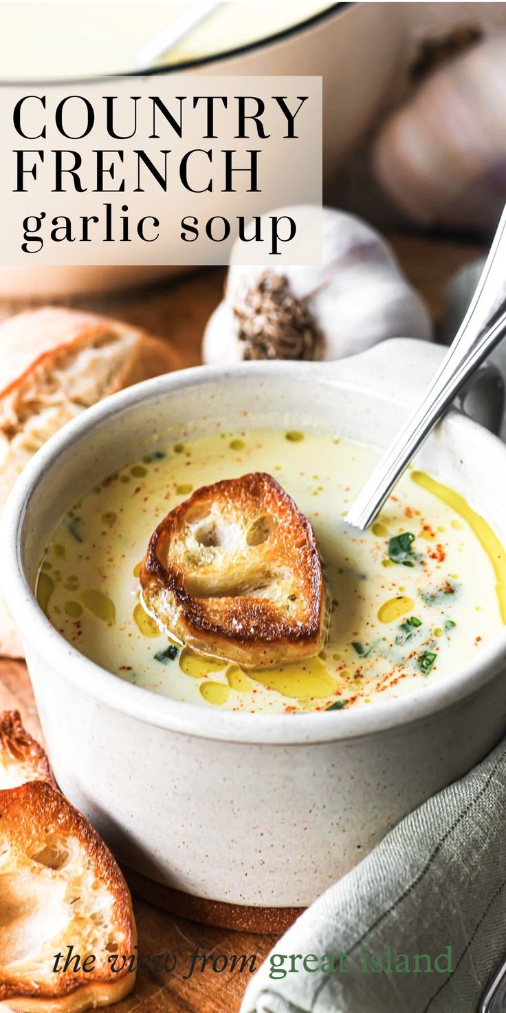 a bowl of soup with bread on the side and text overlay that reads country french garlic soup