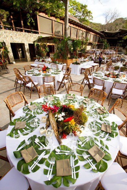 tables and chairs are set up with place settings for guests to sit at the table