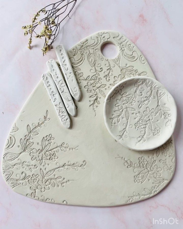 a white ceramic cutting board with spoons and utensils sitting on top of it