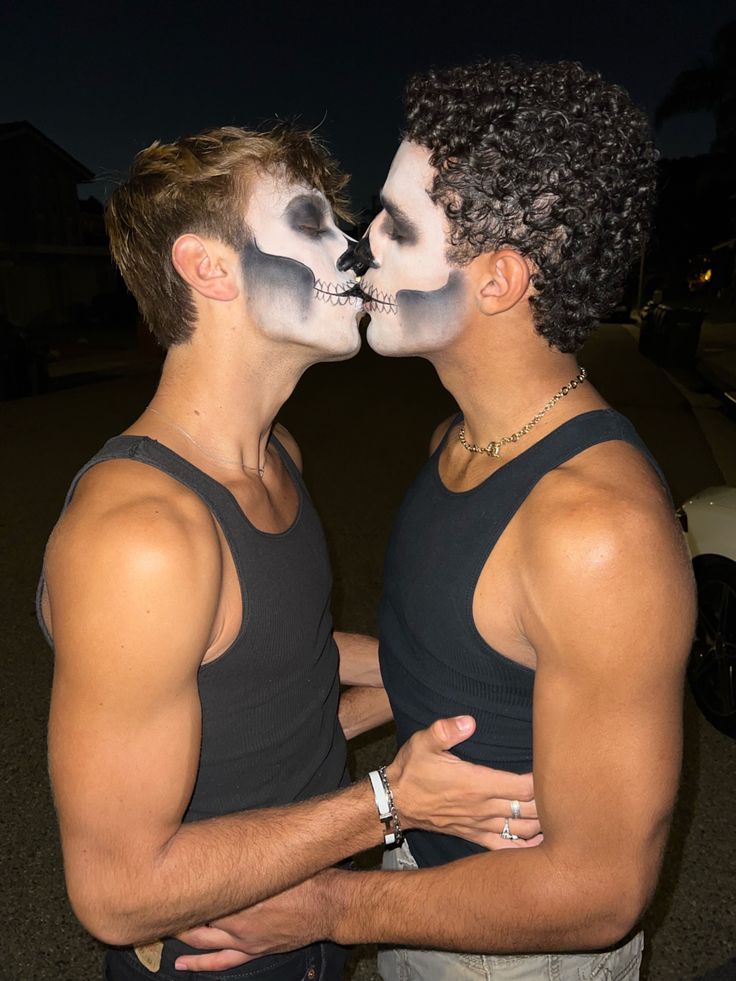 two men with painted faces kissing each other