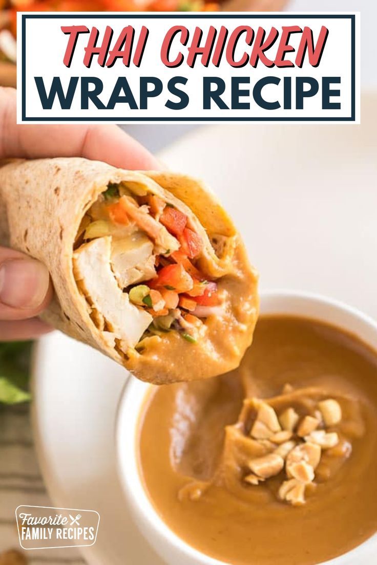 a hand holding a wrap over a bowl of soup with the words thai chicken wraps recipe