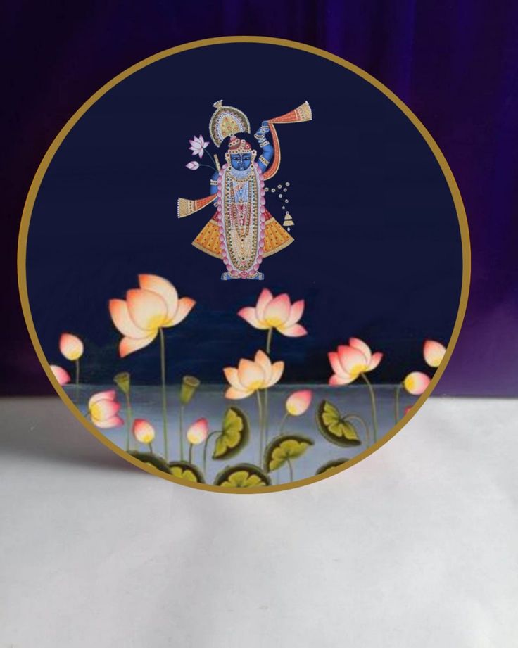 there is a plate with an image of the god on it and flowers in front