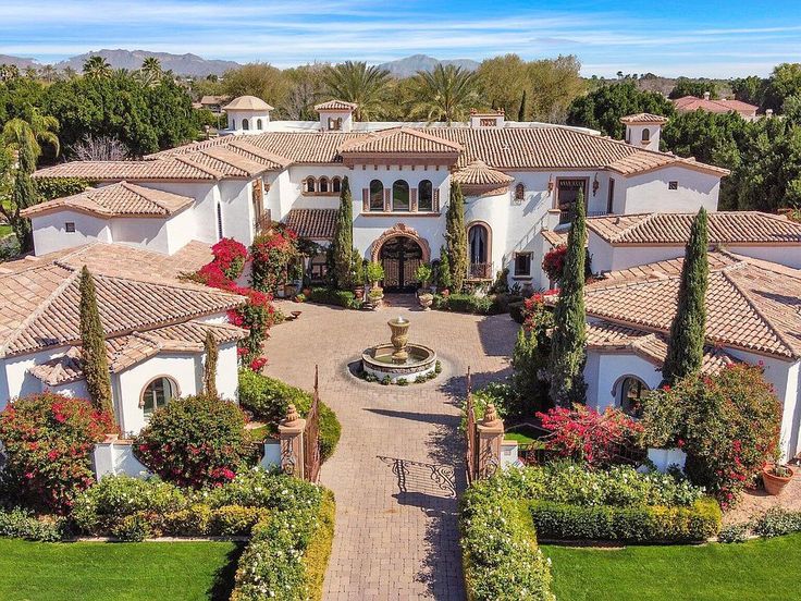 an aerial view of a large home with lots of trees and shrubs in the front yard