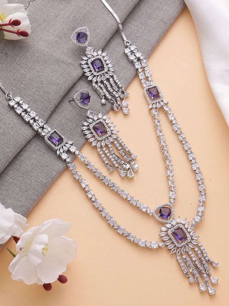 Elevate your style with our Lavender Purple Pendant Set in American Diamond. Delicately crafted to perfection, this charming set features a captivating lavender purple pendant adorned with shimmering American diamonds, exuding grace and elegance. Whether it's a special evening out or a chic daytime affair, this exquisite set adds a touch of sophistication and allure to any ensemble, making it a must-have accessory for every jewelry collection. Also available in light pink and dark green.  Neckla Purple Jewelry Set, Traditional Bridal Jewelry, Lavender Jewellery, Fashion Jewelry Necklaces Gold, Jewelry For Wedding, Purple Pendant, Diamond Necklace Set, Purple Jewelry, Purple Necklace