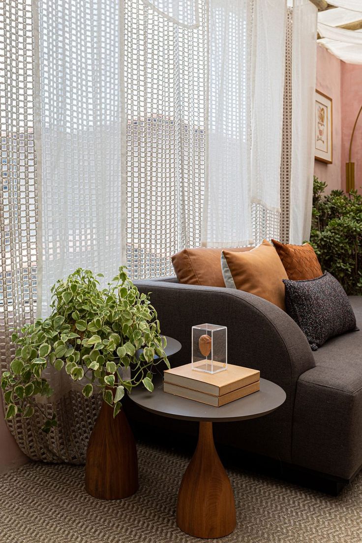 a living room filled with furniture and plants