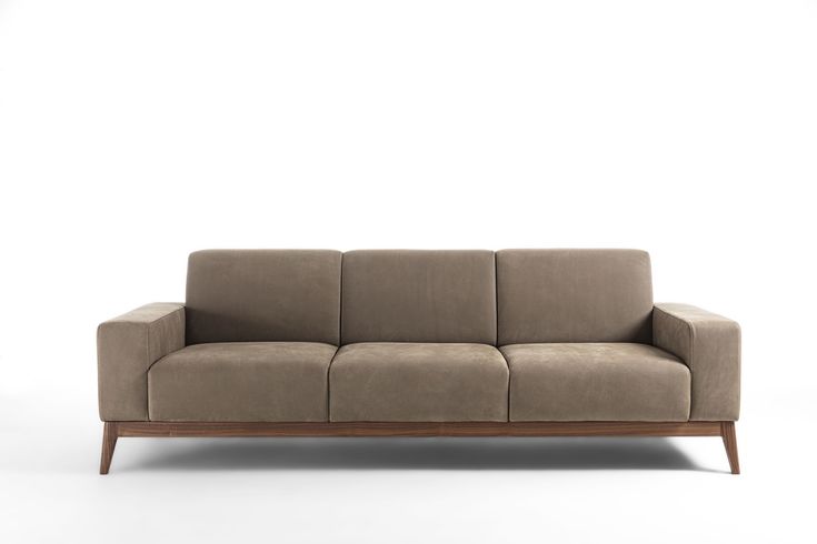 a beige couch sitting on top of a white floor