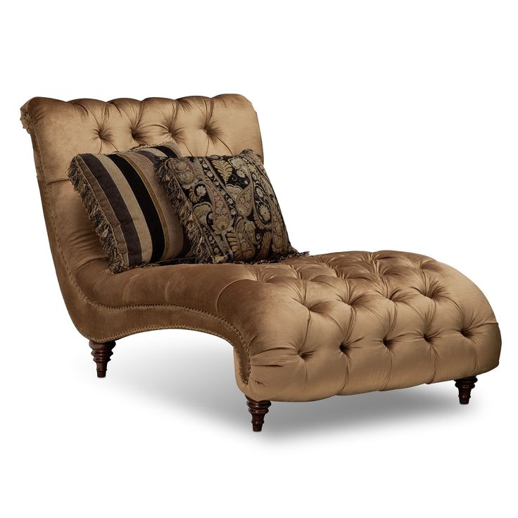 a brown chaise lounge chair with pillows on it