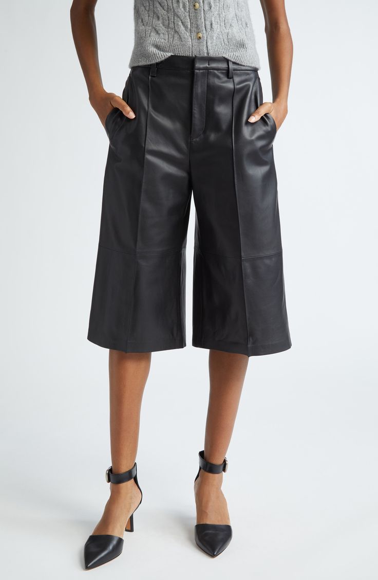 A longer length brings edgy style to these leather shorts that'll smoothly slip into high rotation with their versatile design. 16" inseam; 26" leg opening; 11" front rise; 13 1/2" back rise (size 8) Zip fly with hook-and-bar closure Front slant pockets; back welt pockets Leather Professional leather clean Imported Edgy Black Knee-length Bottoms, Edgy Knee-length Black Bottoms, Modern Leather Bottoms For Spring, Modern Leather Bottoms For Fall, Short Leather Bottoms With Belt Loops, Knee-length Faux Leather Bottoms For Night Out, Fitted Leather Shorts For Work, Modern High-waist Leather Pants, Modern Wide Leg Leather Bottoms