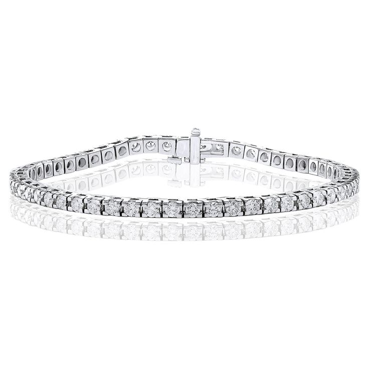 A classic tennis bracelet style showcasing a row of round brilliant diamonds, set in a polished 14k white gold mounting. 55 Diamonds weigh 3.00 carats total and are approximately GH color, SI1 clarity. Style available in different price ranges. Prices are based on your selection of the 4C’s (Carat, Color, Clarity, Cut). Please contact us for more information. Bracelet Tennis, Diamond Tiara, Diamond Tennis Bracelet, Bracelet Style, Tennis Bracelet Diamond, Brilliant Diamond, Tennis Bracelet, Round Brilliant, Round Diamond