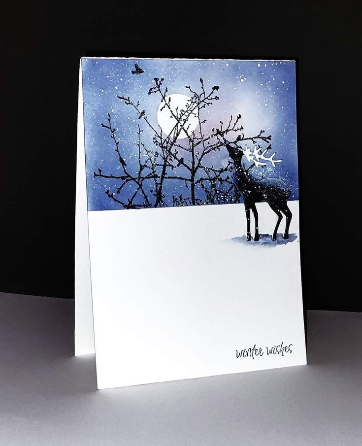 a greeting card with a deer in the snow and a full moon behind it that says winter wishes