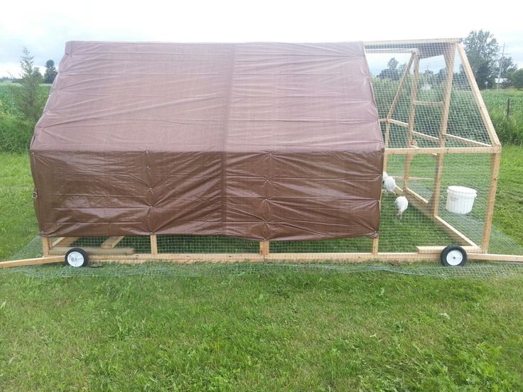 a chicken coop with a cover over it