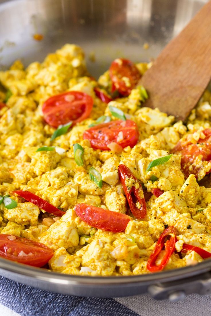 a pan filled with scrambled eggs and tomatoes