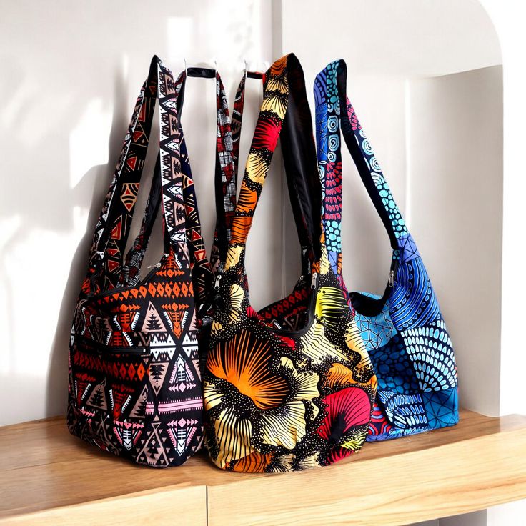 This African Print Cross Bag is the perfect accessory for any style! This bag features a large capacity with pockets and a zip closure, making it the perfect choice for carrying all of your essentials. It's stylish, lightweight, and comfortable, making it great for everyday use. Plus, its unique African print design will make a bold statement wherever you go! Summer Canvas Shoulder Bag For On-the-go, Summer Shopping Shoulder Bag With Pockets, Summer Shoulder Bag For On-the-go, Multicolor Bucket Shoulder Bag For Travel, Multicolor Hobo Shoulder Bag For Travel, Casual Multicolor Shoulder Bag With Large Capacity, Casual Multicolor Large Capacity Shoulder Bag, Large Capacity Multicolor Canvas Shoulder Bag, Large Capacity Hobo Shoulder Bag For Travel